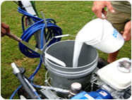 Pour field marking paint concentrate in bucket.
