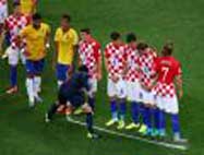 Soccer referee vanishing foam spray can to mark free kick spot and player wall.